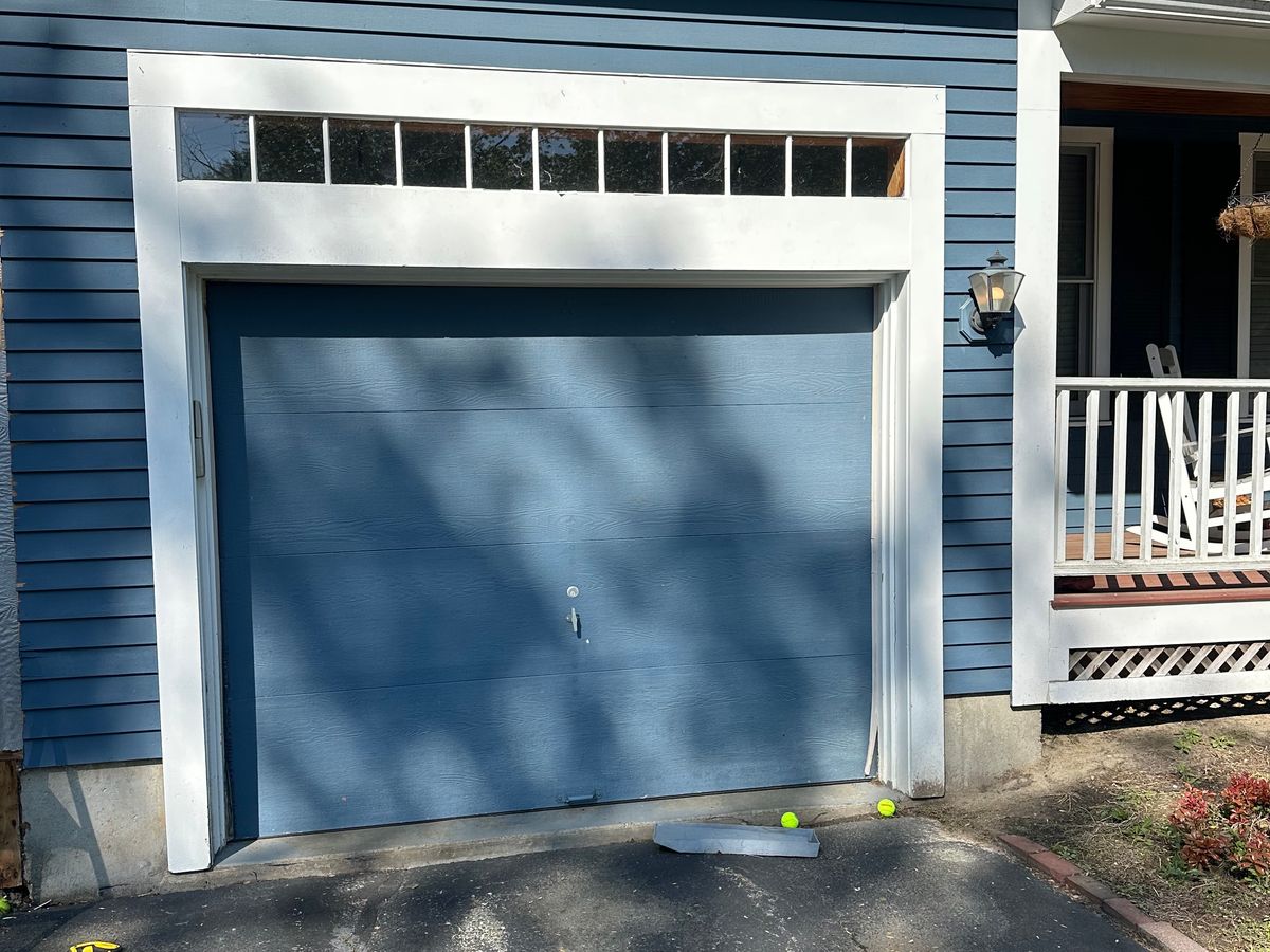 Modern blue garage door with clean lines on contemporary home